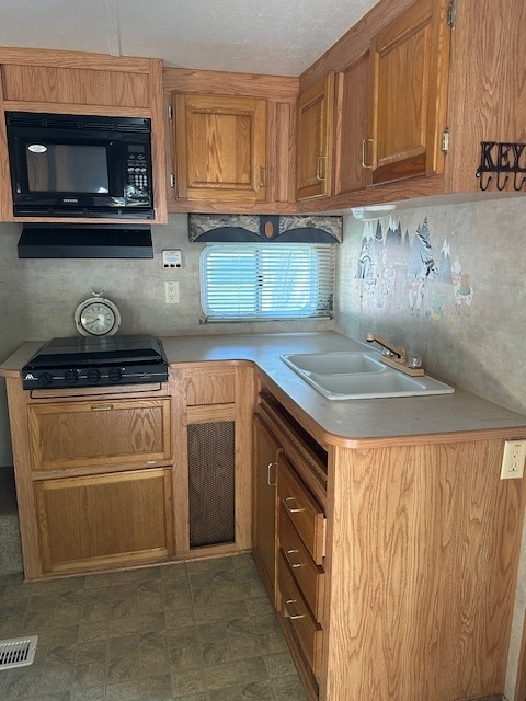 25-37 Woodhaven Sublette, IL 61367 - Photo 6 of 13 a kitchen with a stove and a microwave