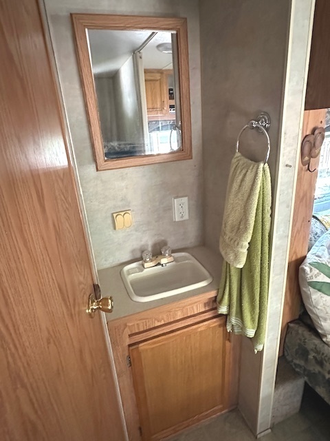 25-37 Woodhaven Sublette, IL 61367 - Photo 9 of 13 a bathroom with a sink a toilet and mirror