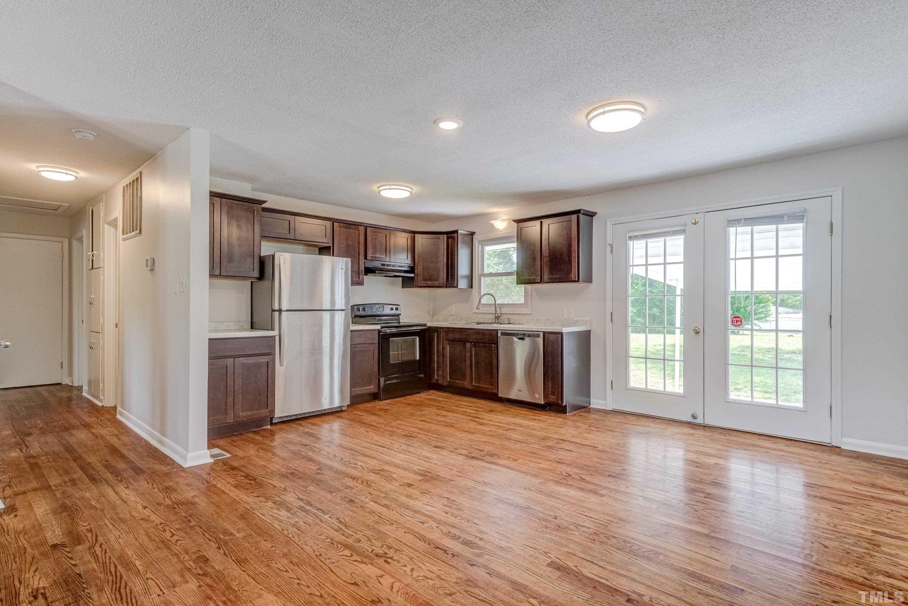 3840 Marsh Creek Road Raleigh, NC 27604 - Photo 17 of 41 a kitchen with stainless steel appliances granite countertop a refrigerator and a stove top oven