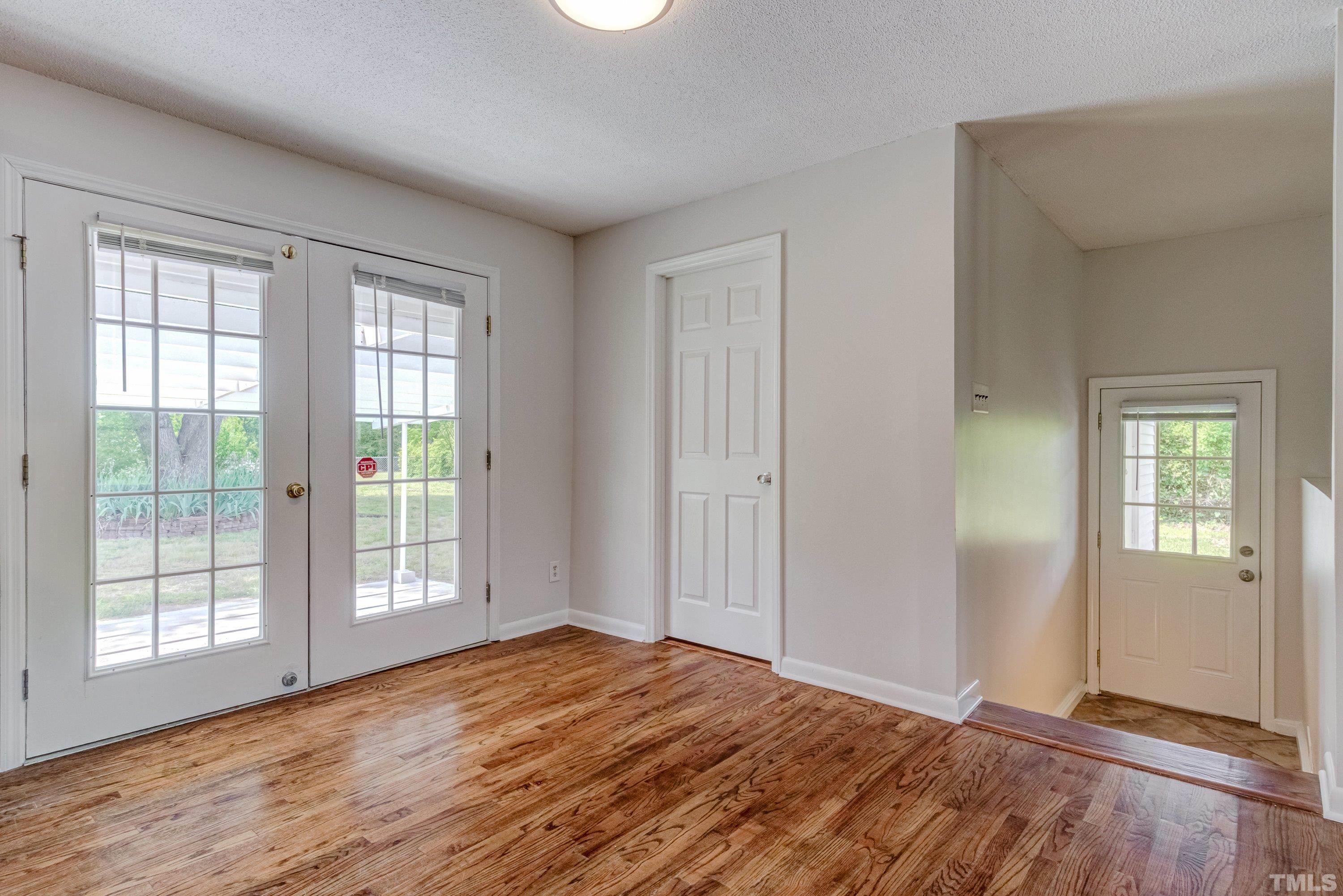3840 Marsh Creek Road Raleigh, NC 27604 - Photo 19 of 41 a view of empty room with wooden floor and fan