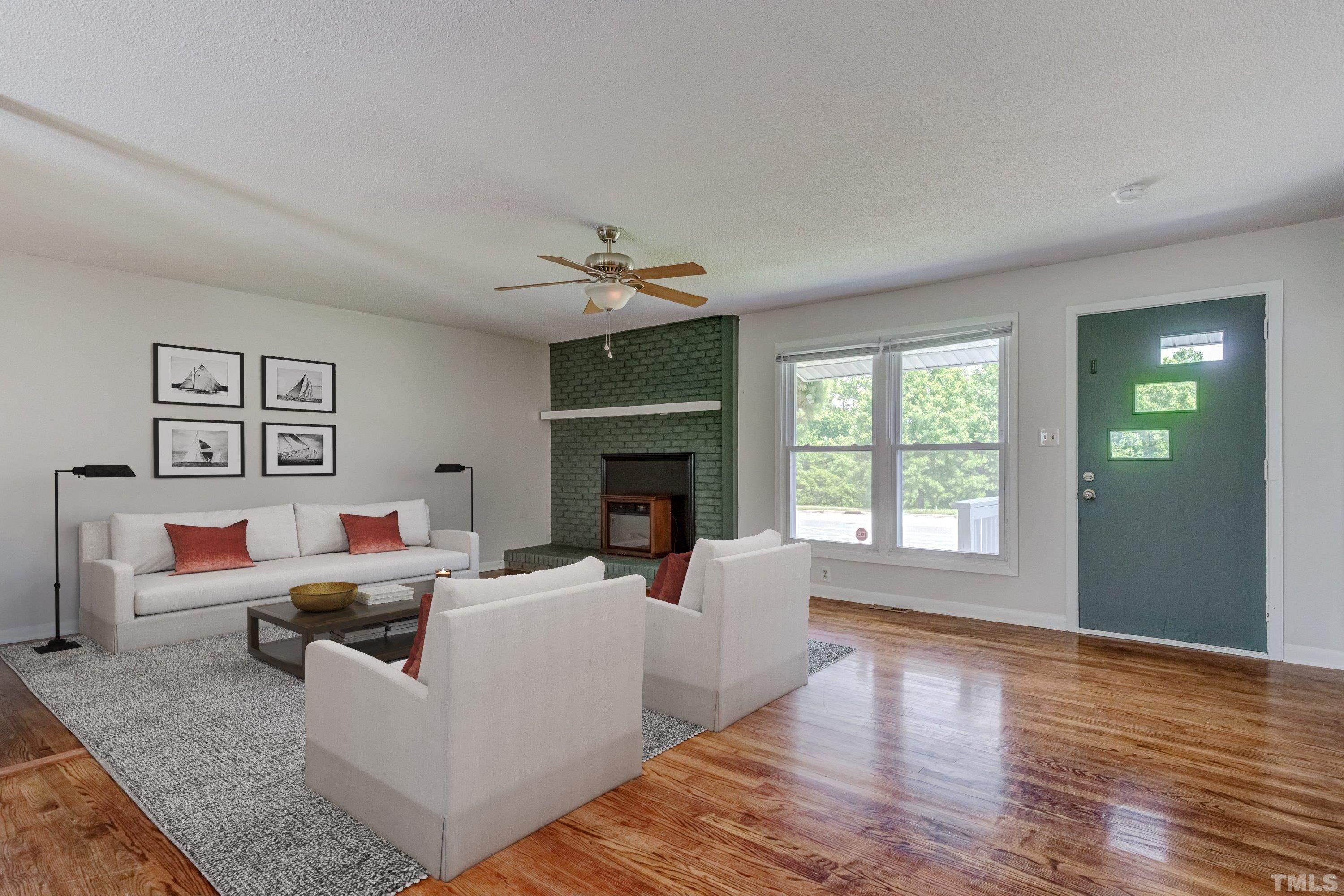 3840 Marsh Creek Road Raleigh, NC 27604 - Photo 20 of 41 a living room with furniture and a fireplace
