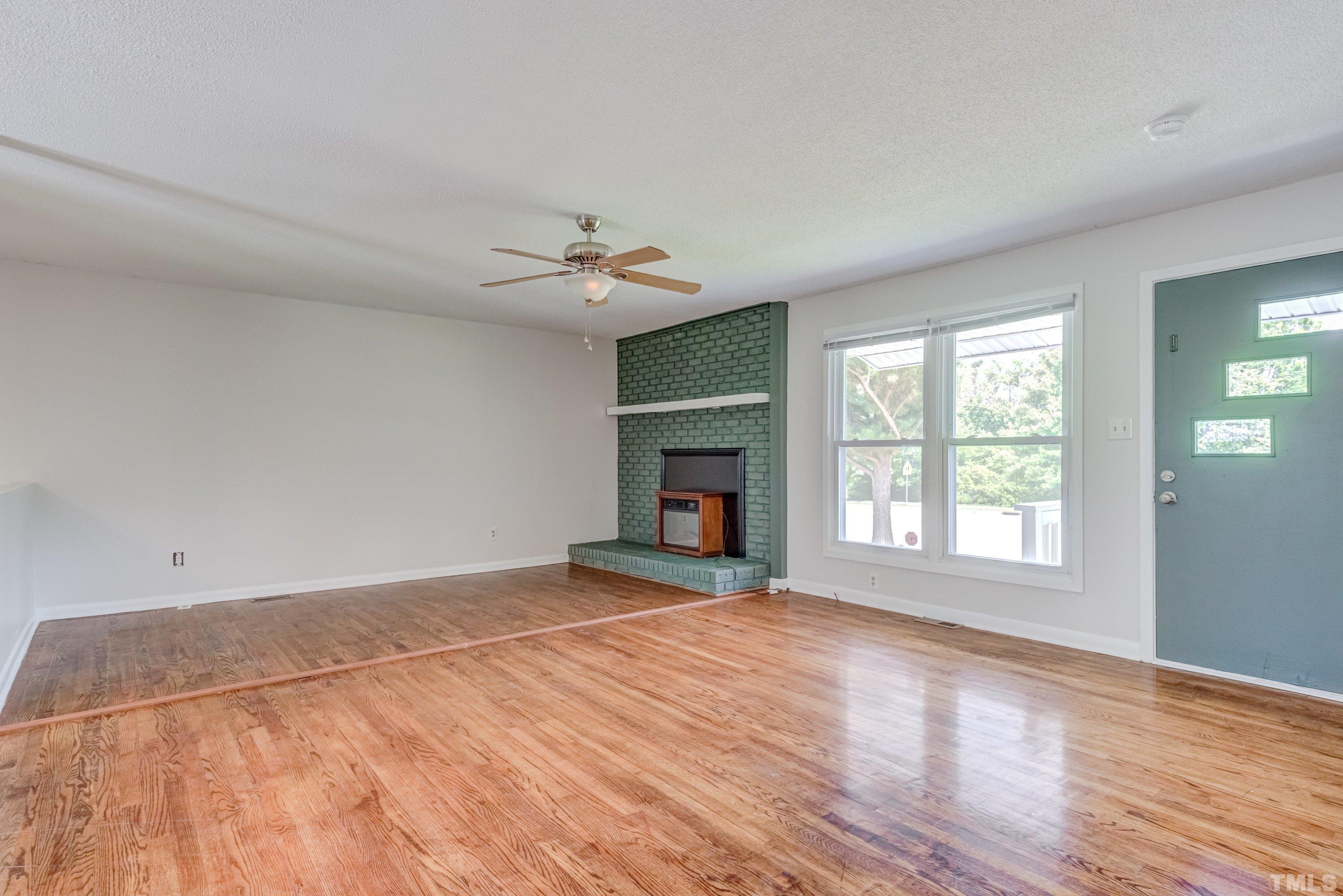 3840 Marsh Creek Road Raleigh, NC 27604 - Photo 21 of 41 a view of an empty room with a window and fireplace
