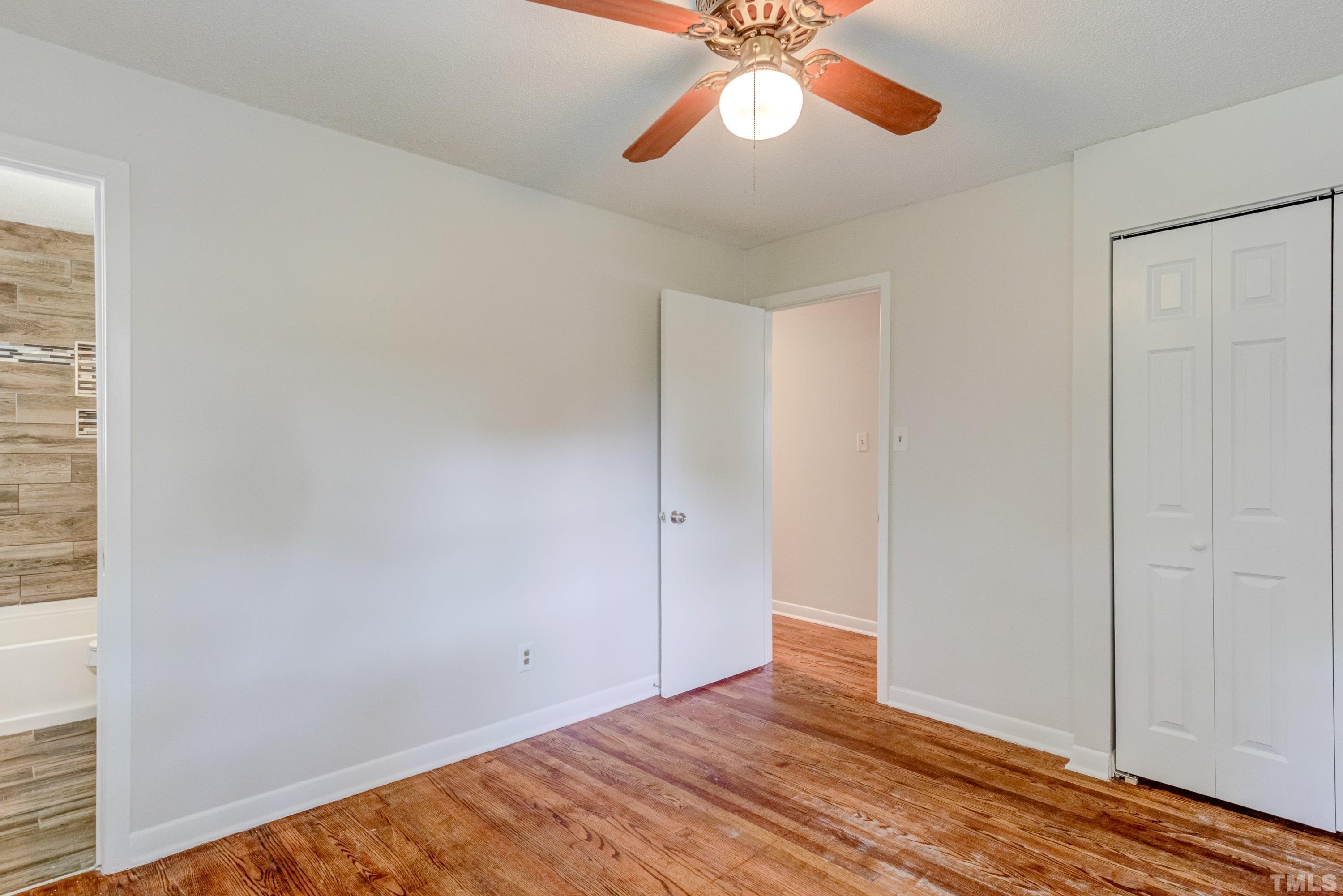 3840 Marsh Creek Road Raleigh, NC 27604 - Photo 23 of 41 a view of an empty room with wooden floor