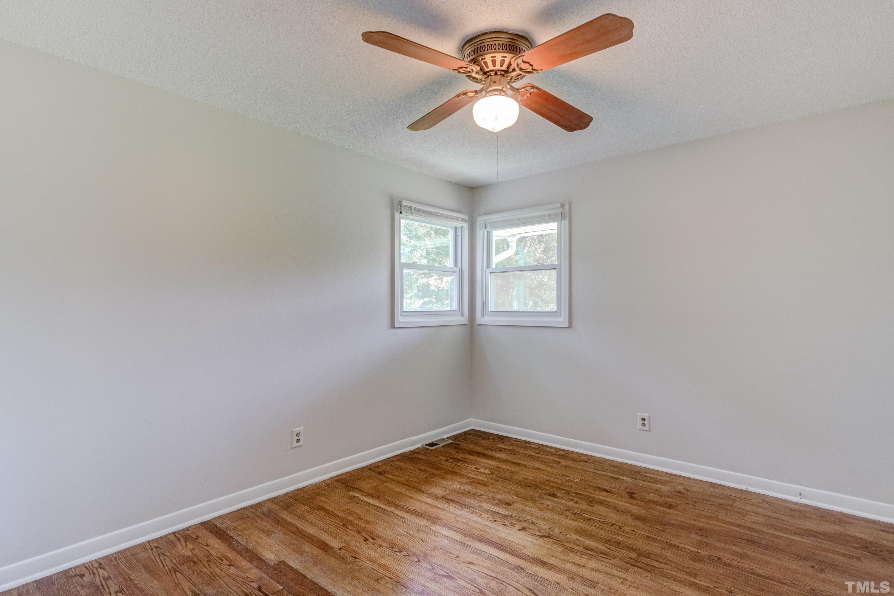 3840 Marsh Creek Road Raleigh, NC 27604 - Photo 24 of 41 an empty room with wooden floor and windows