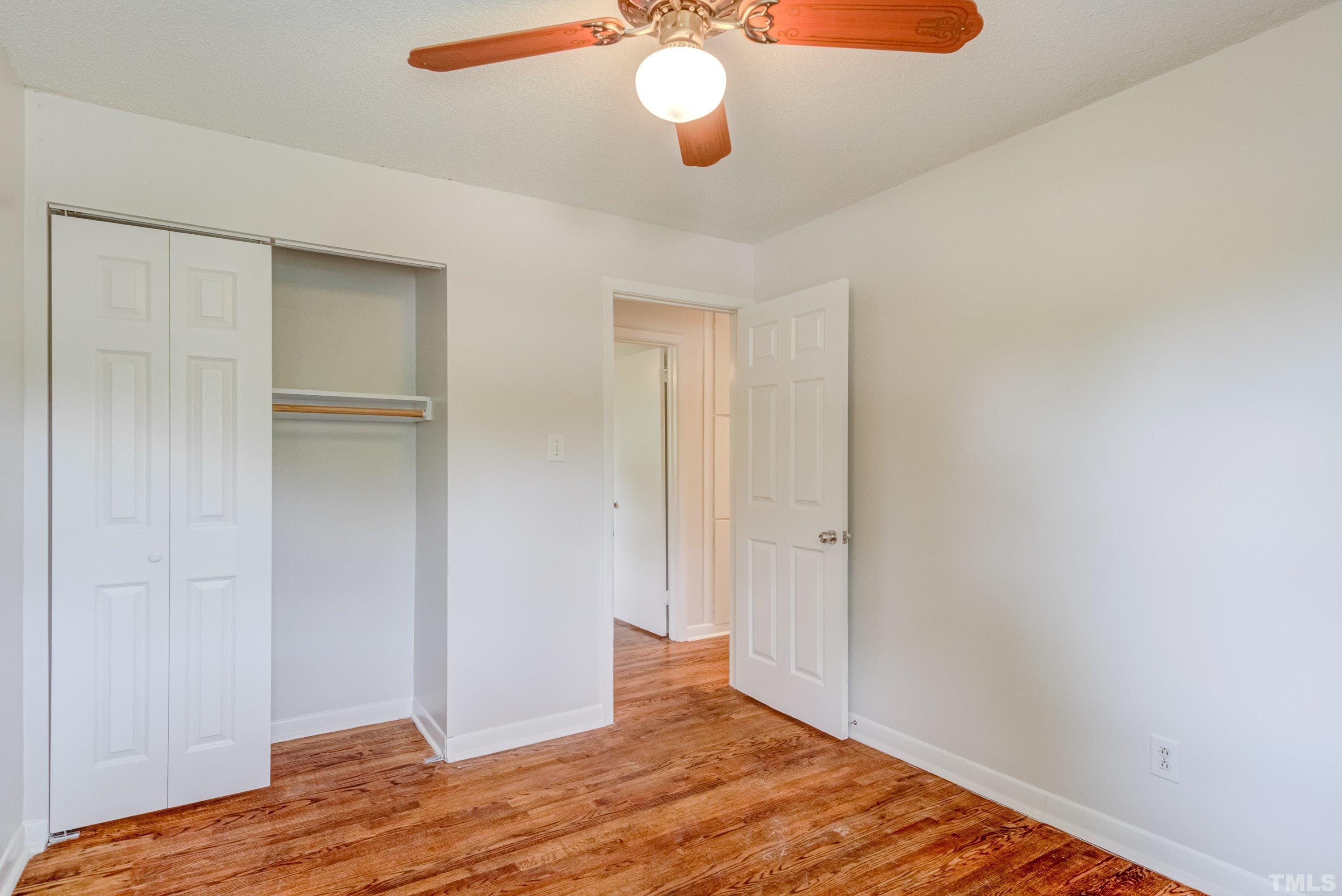 3840 Marsh Creek Road Raleigh, NC 27604 - Photo 25 of 41 a view of a room with wooden floor and ceiling fan