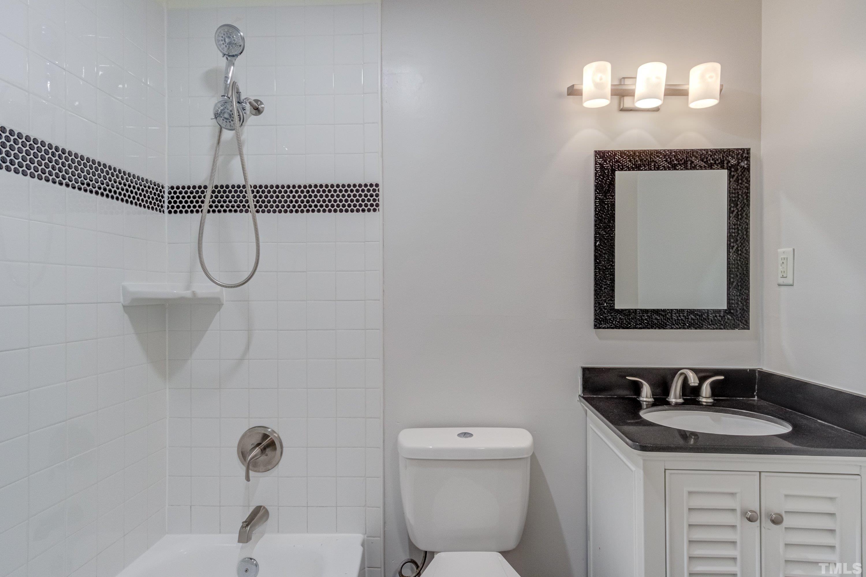 3840 Marsh Creek Road Raleigh, NC 27604 - Photo 27 of 41 a bathroom with a granite countertop sink a toilet and mirror