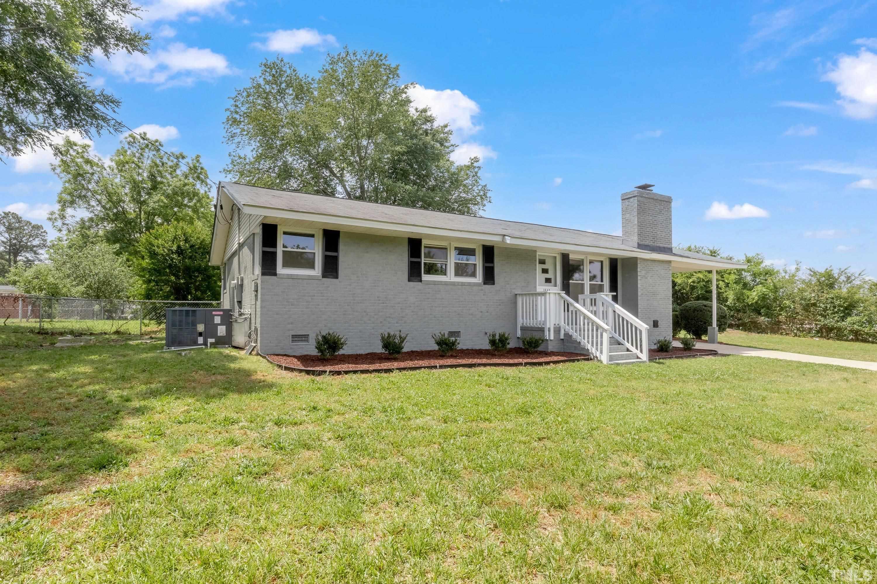3840 Marsh Creek Road Raleigh, NC 27604 - Photo 3 of 41 a house view with a sitting space and garden