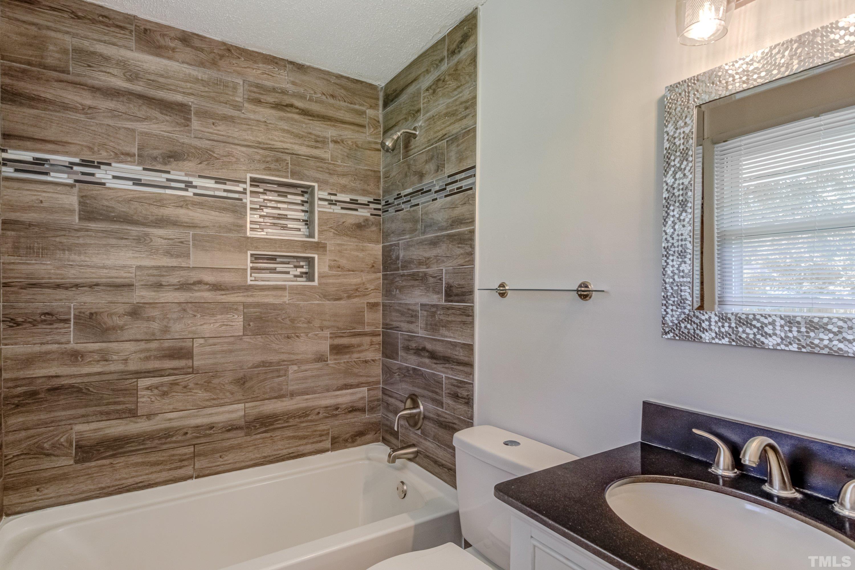 3840 Marsh Creek Road Raleigh, NC 27604 - Photo 33 of 41 a bathroom with a granite countertop sink toilet and shower