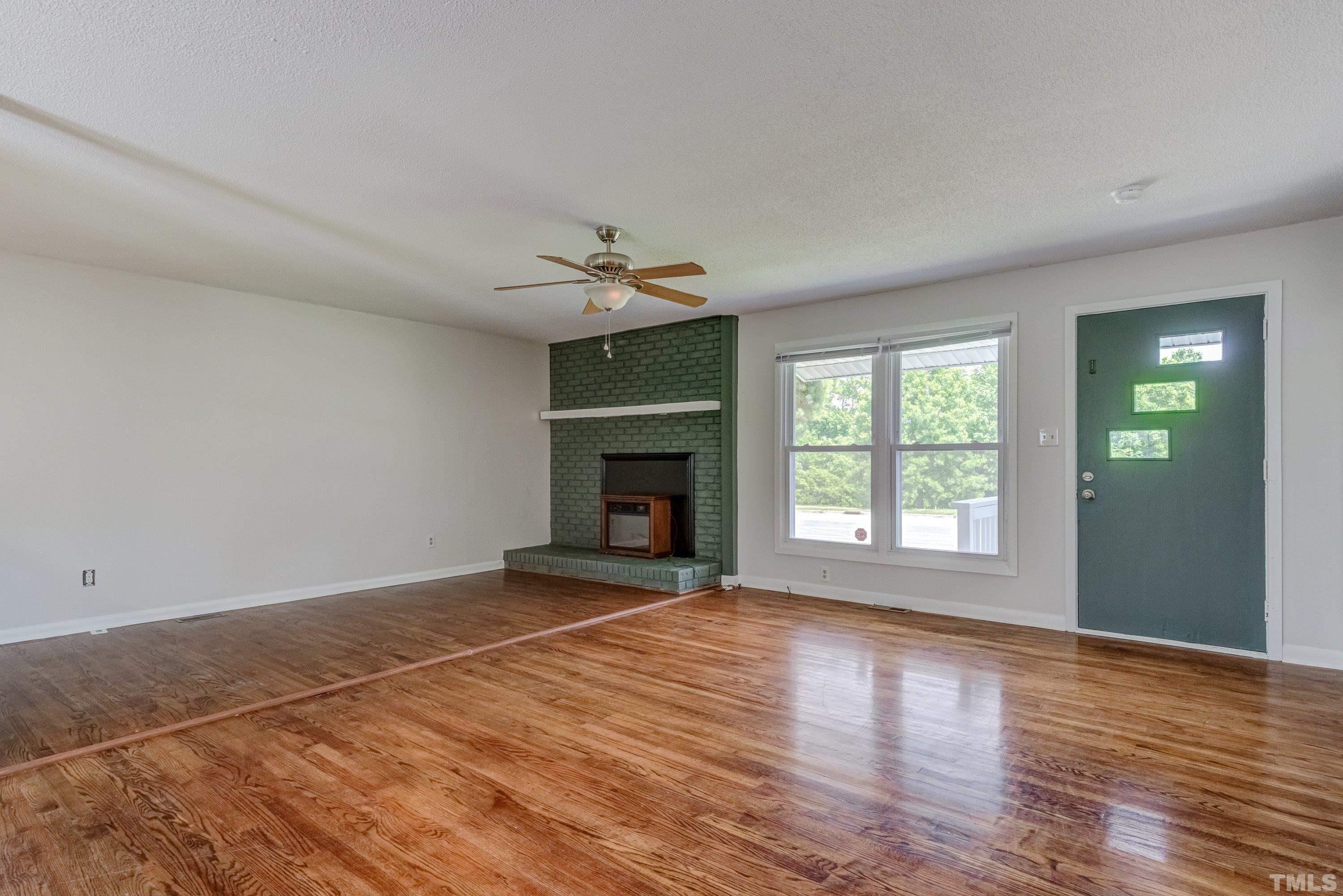 3840 Marsh Creek Road Raleigh, NC 27604 - Photo 8 of 41 a view of an empty room with glass door and wooden floor