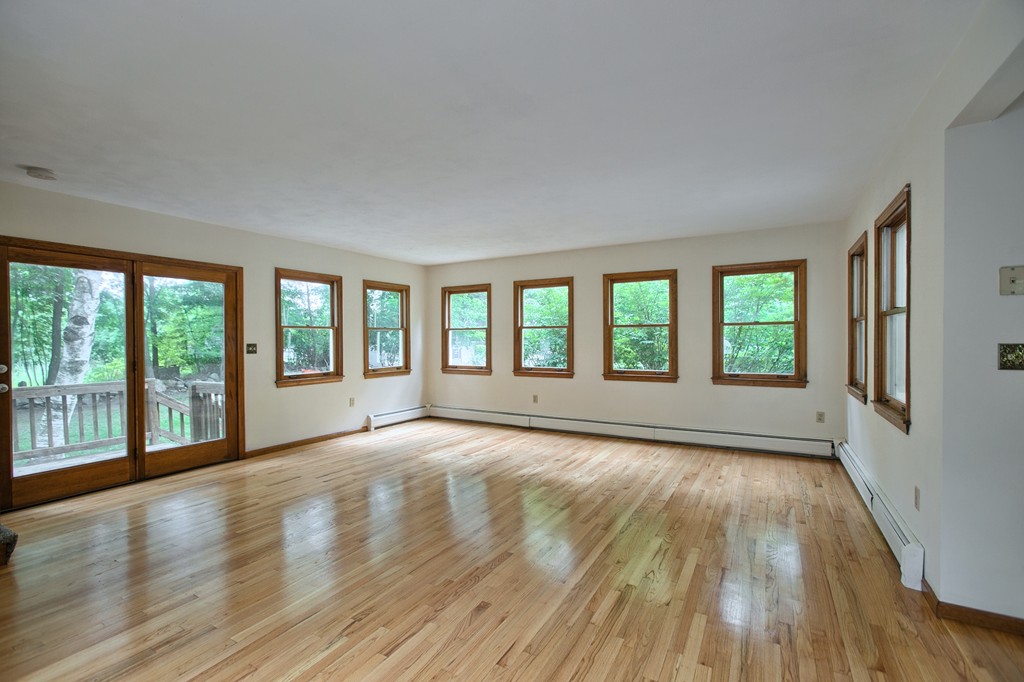 27 Andover Road, Unit 2 Billerica, MA 01821 - Photo 10 of 23 a view of an empty room with wooden floor and a window