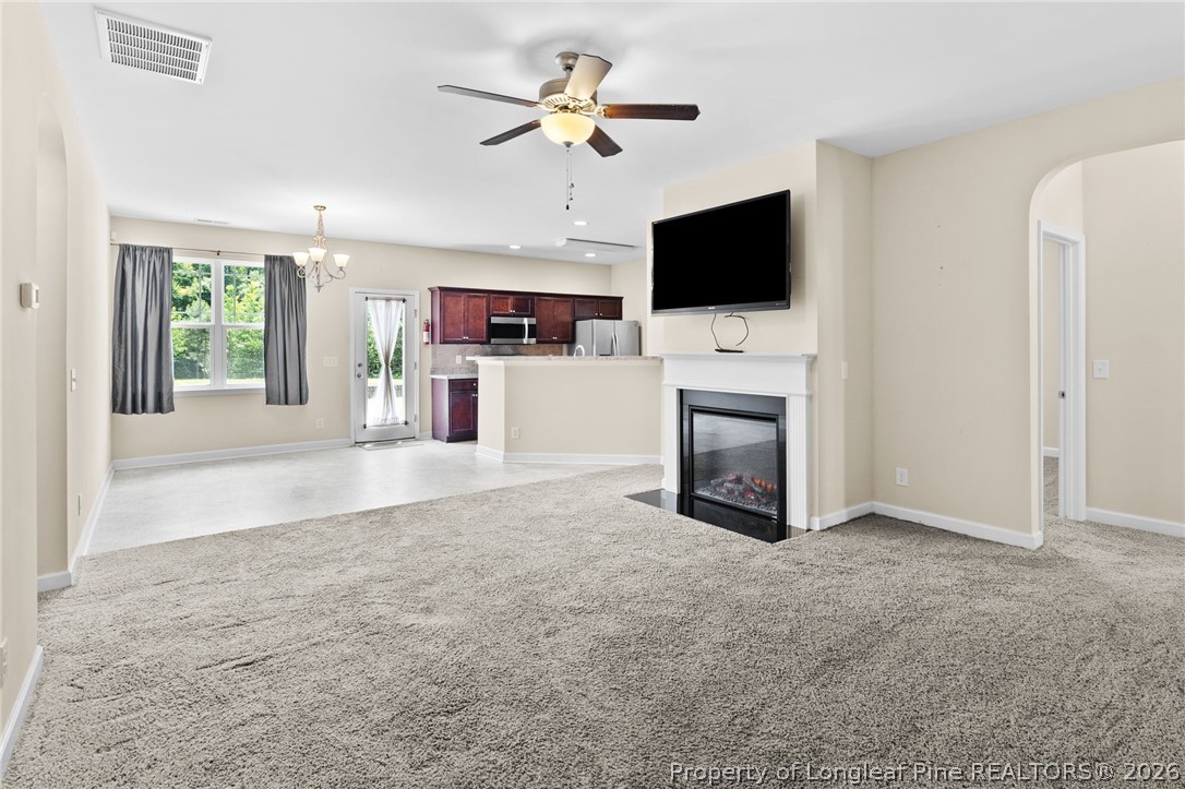 216 Meherrin Loop Raeford, NC 28376 - Photo 6 of 38 a view of a livingroom with a fireplace a microwave and a flat screen tv