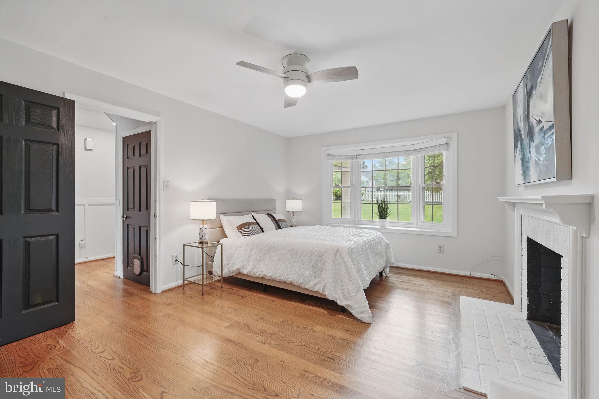 11340 Waples Mill Road Oakton, VA 22124 - Photo 11 of 34 a spacious bedroom with a large bed and a chandelier