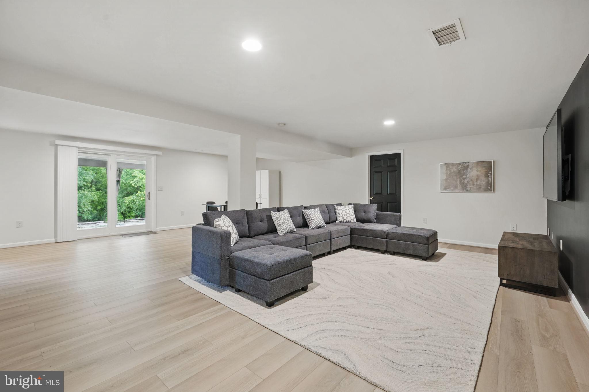 11340 Waples Mill Road Oakton, VA 22124 - Photo 19 of 34 a living room with furniture and a flat screen tv