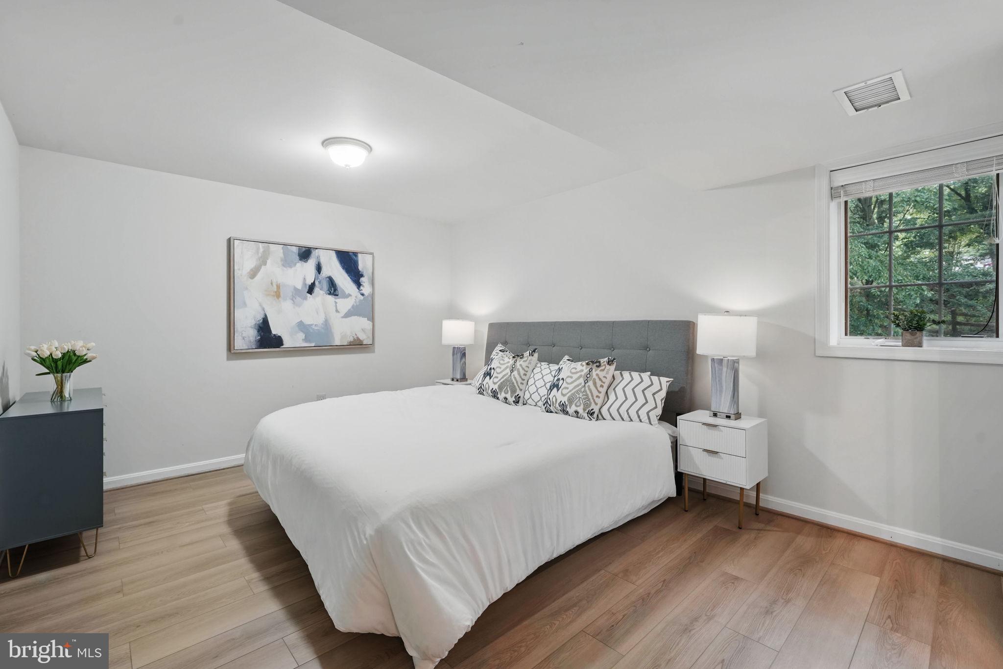 11340 Waples Mill Road Oakton, VA 22124 - Photo 20 of 34 a bedroom with a large bed and a potted plant