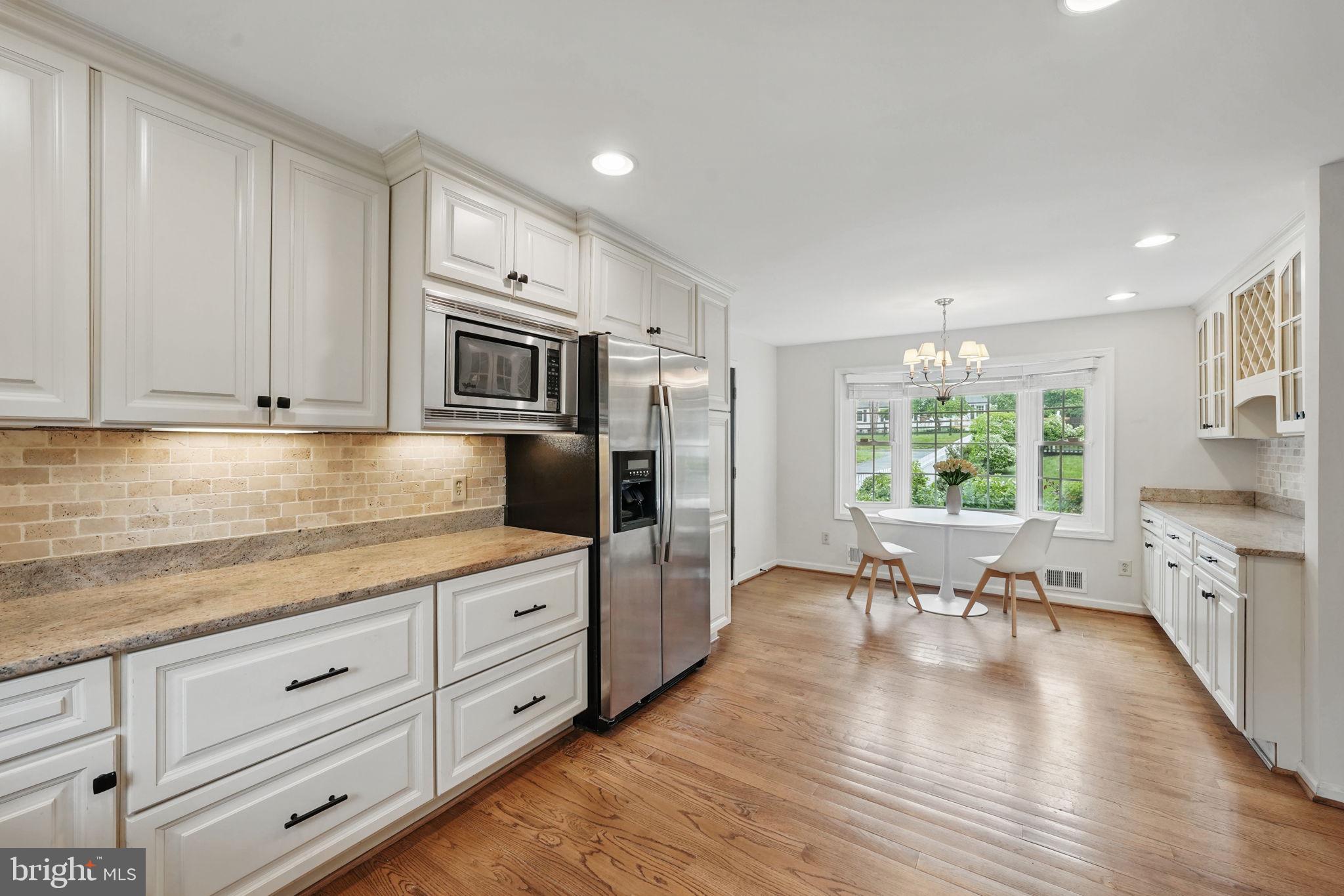 11340 Waples Mill Road Oakton, VA 22124 - Photo 9 of 34 a kitchen with granite countertop white cabinets and stainless steel appliances