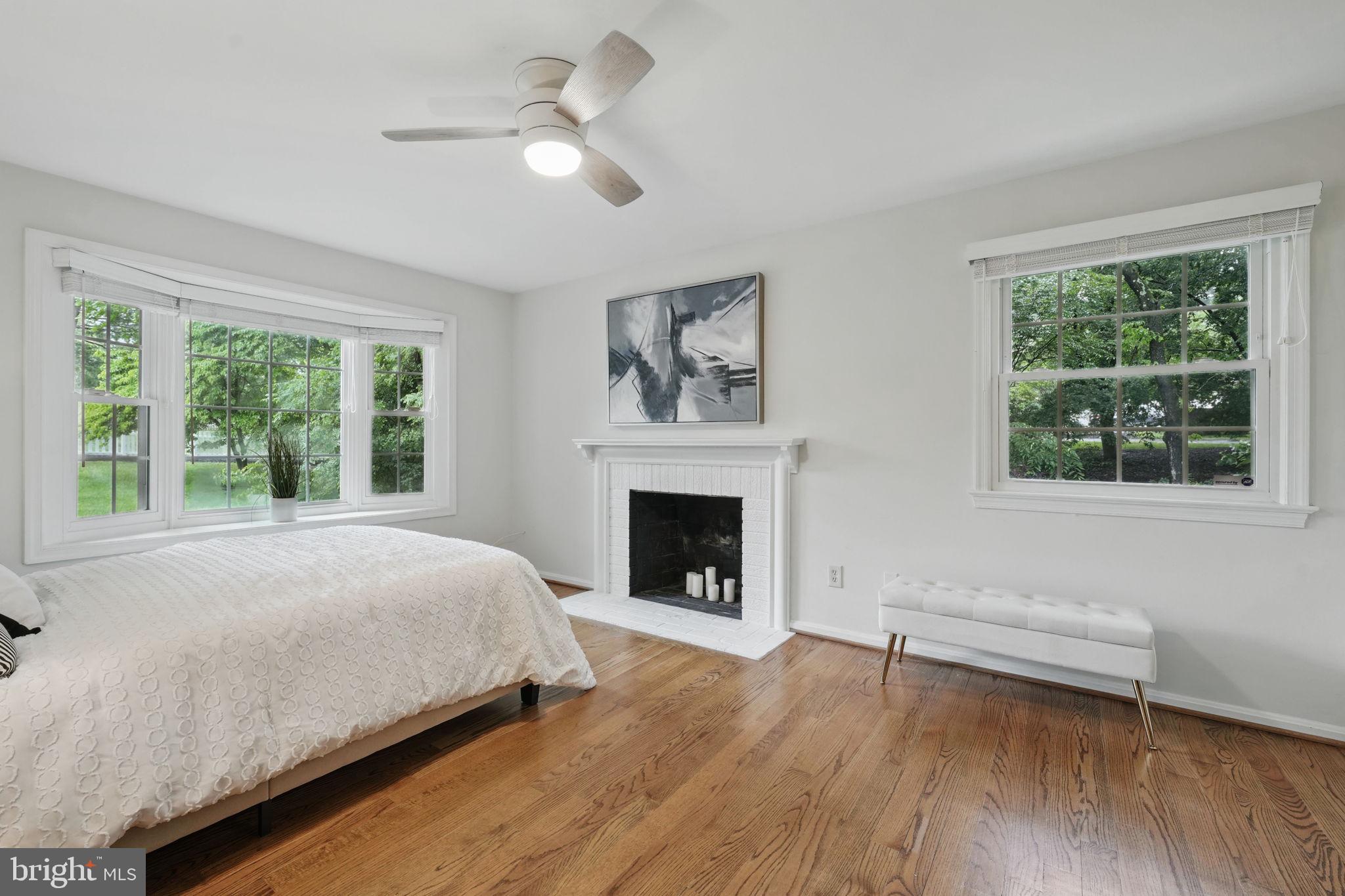 11340 Waples Mill Road Oakton, VA 22124 - Photo 10 of 34 a bed sitting in a room next to a window and a fireplace