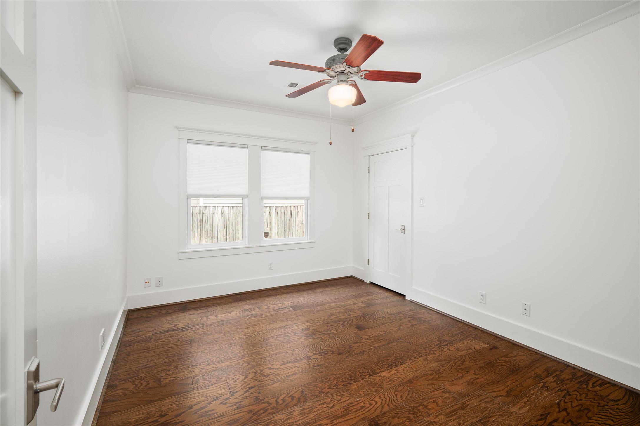 714 Wilken Street Houston, TX 77008 - Photo 15 of 35 an empty room with wooden floor fan and windows