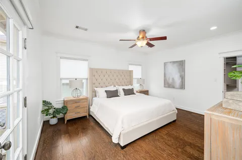 a bedroom with a bed chandelier and a window