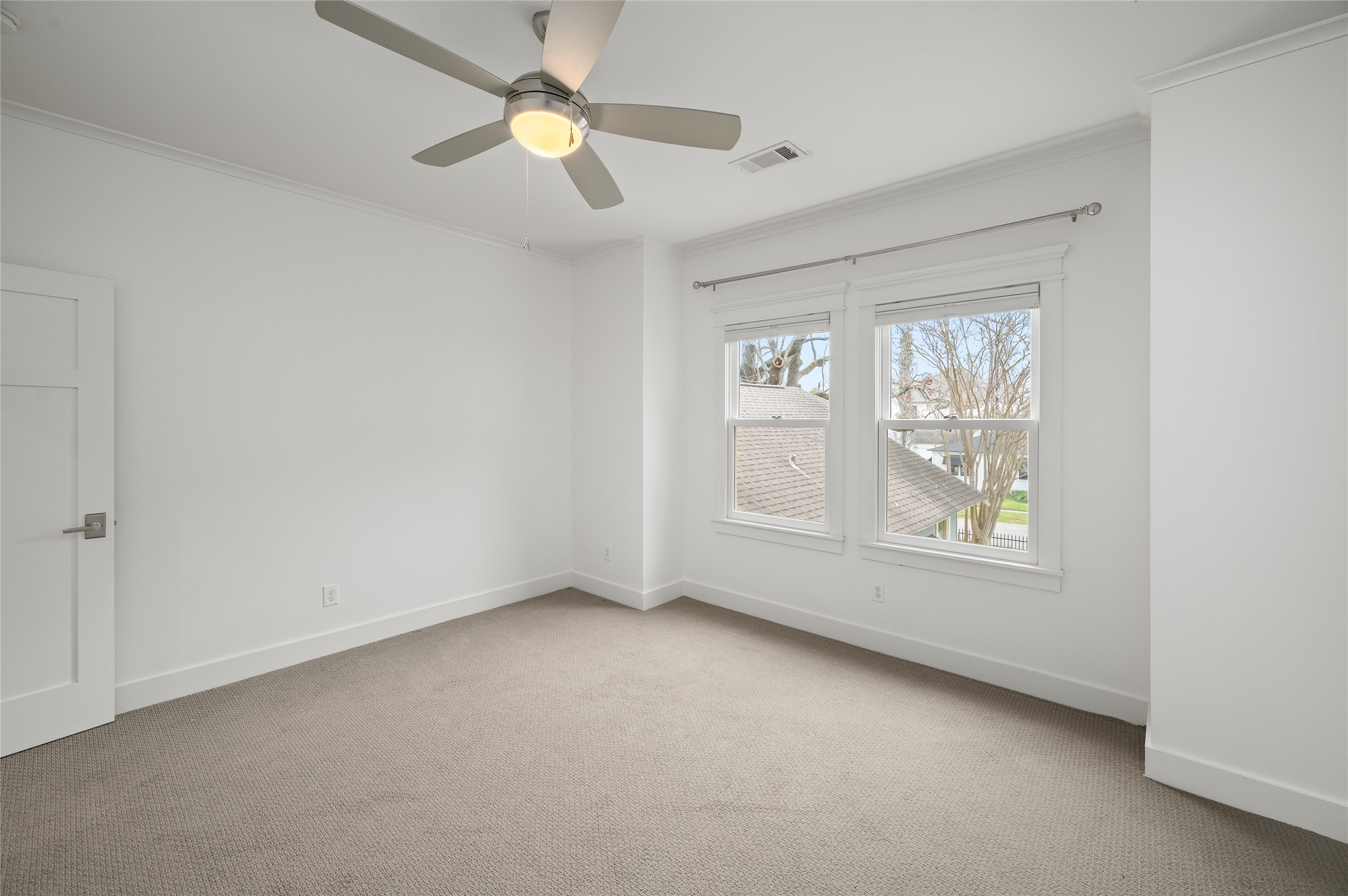 714 Wilken Street Houston, TX 77008 - Photo 24 of 35 an empty room with windows and fan