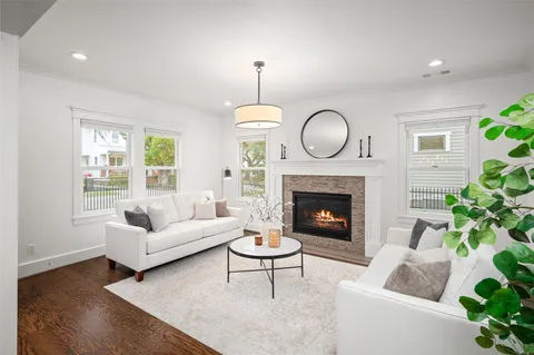 a living room with furniture a table and a potted plant
