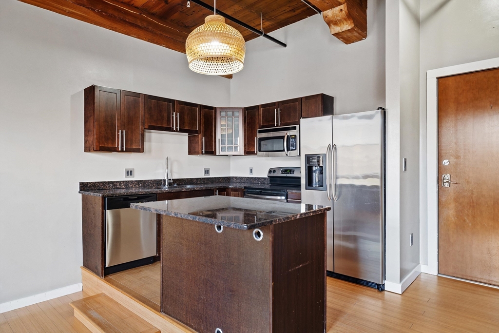 1511 Main Street, Unit C306 Worcester, MA 01603 - Photo 12 of 33 a kitchen with stainless steel appliances granite countertop a stove a refrigerator and a sink