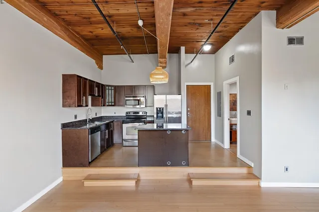 a kitchen with a refrigerator a stove and a cabinets