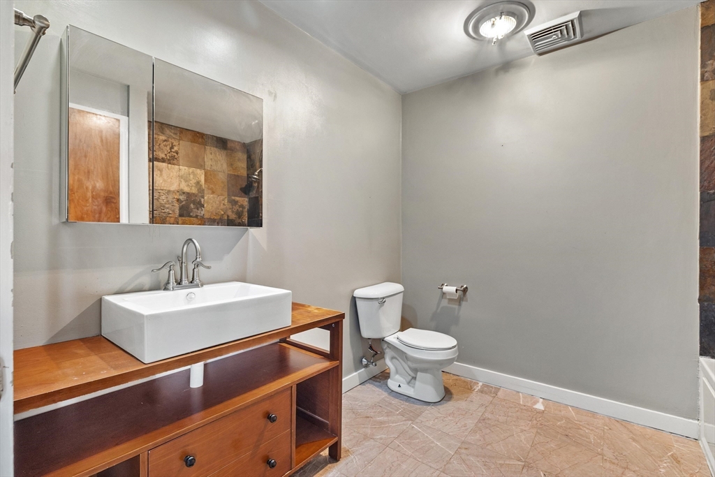 1511 Main Street, Unit C306 Worcester, MA 01603 - Photo 21 of 33 a bathroom with a sink a toilet and mirror