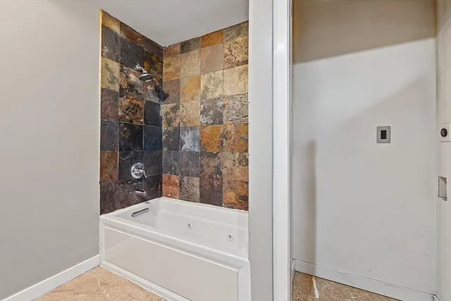 a bathroom with a bathtub and a shower