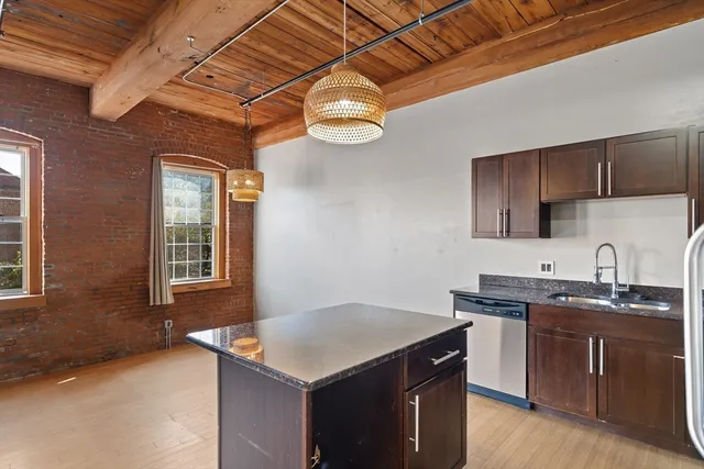 a kitchen with a sink a stove and cabinets