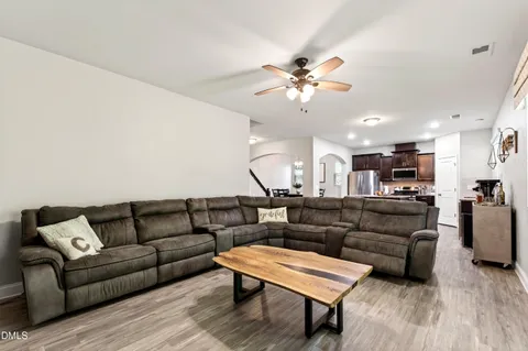a living room with furniture and a wooden floor