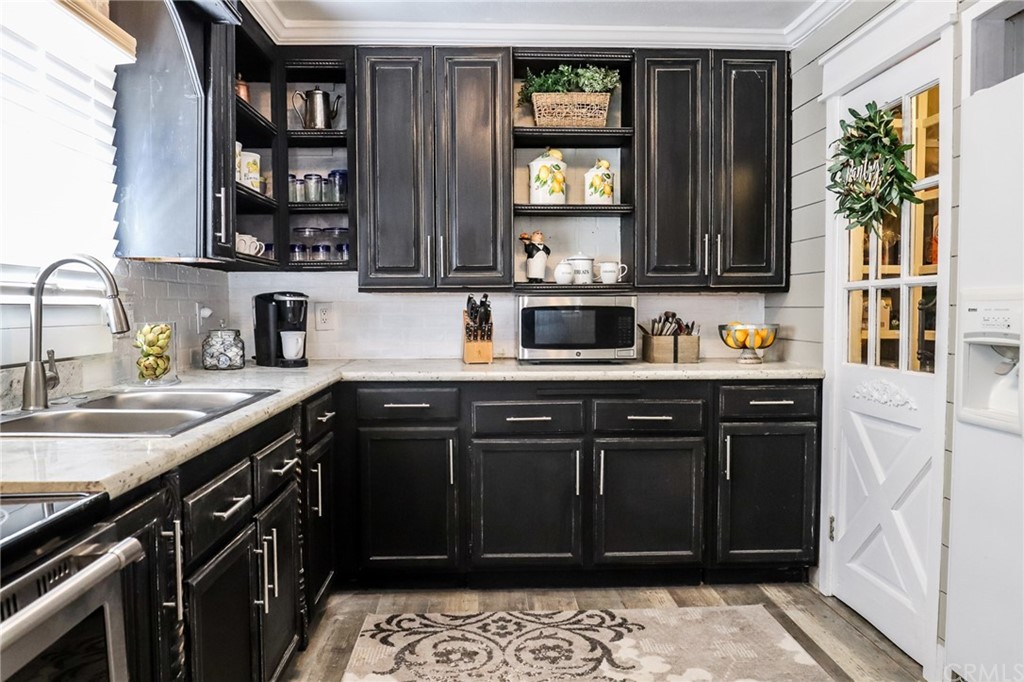 304 C Street Needles, CA 92363 - Photo 33 of 57 a kitchen with a sink stove top oven and cabinets