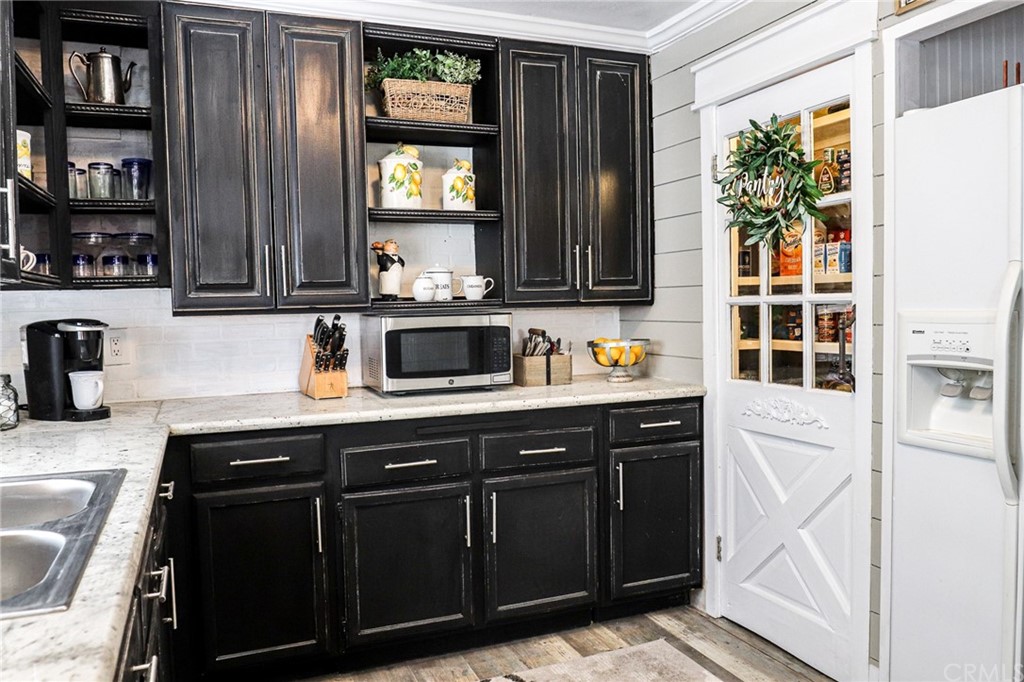 304 C Street Needles, CA 92363 - Photo 34 of 57 a kitchen with stainless steel appliances granite countertop a stove and a sink