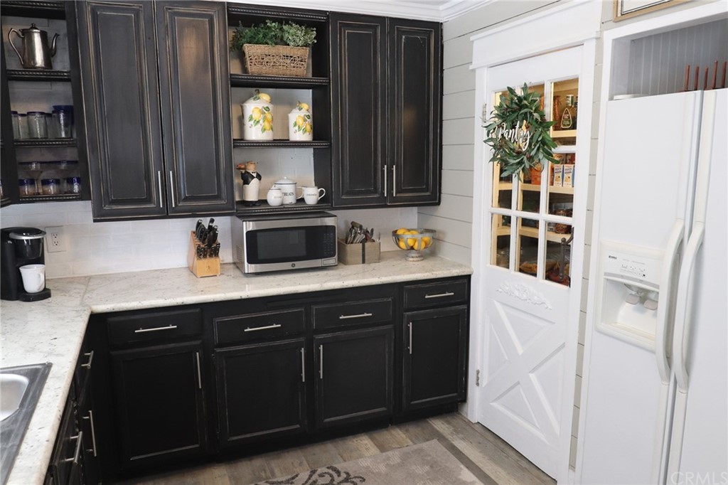 304 C Street Needles, CA 92363 - Photo 35 of 57 a kitchen with granite countertop a refrigerator and cabinets