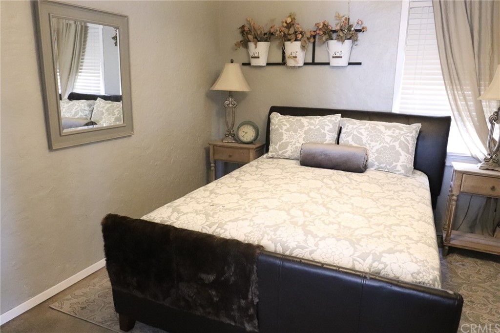 304 C Street Needles, CA 92363 - Photo 39 of 57 a bed sitting in a bedroom next to a window