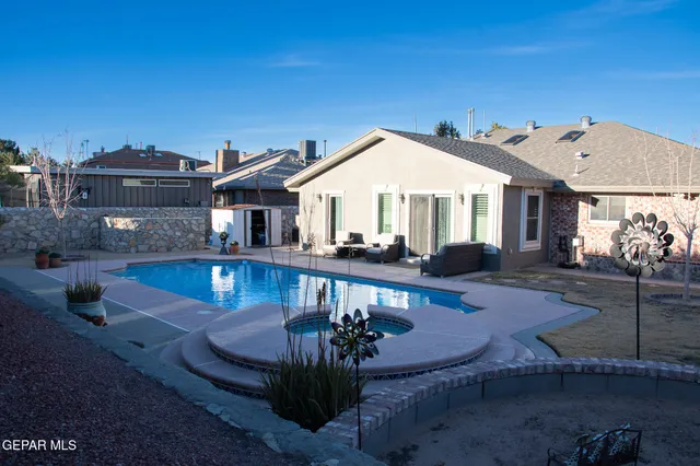 a view of a house with pool yard and a sitting area