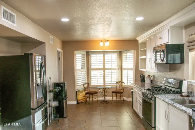 a kitchen with lots of counter top space and stainless steel appliances