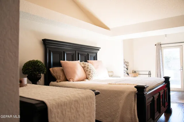 a bedroom with a large bed and a dresser