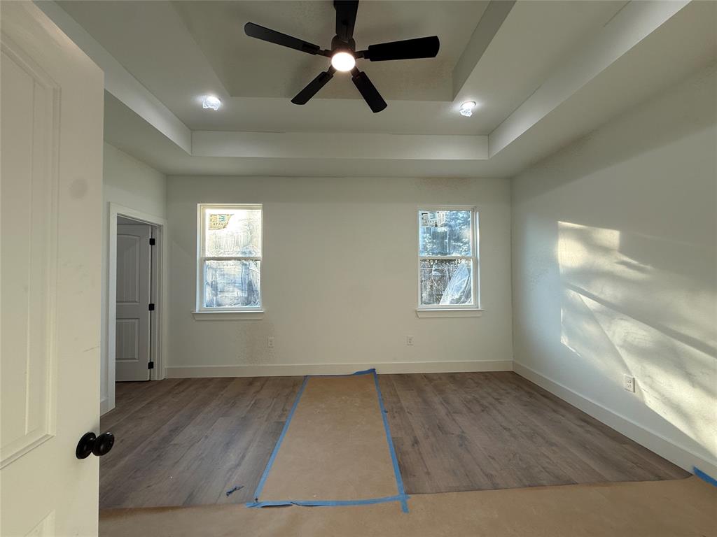5803 Plum Dale Road Dallas, TX 75241 - Photo 5 of 14 an empty room with windows and fan