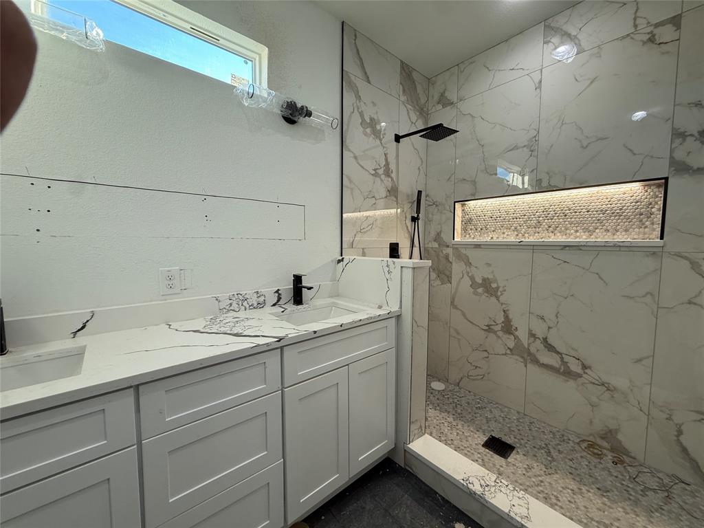 5803 Plum Dale Road Dallas, TX 75241 - Photo 6 of 14 a bathroom with a granite countertop sink a shower and a mirror