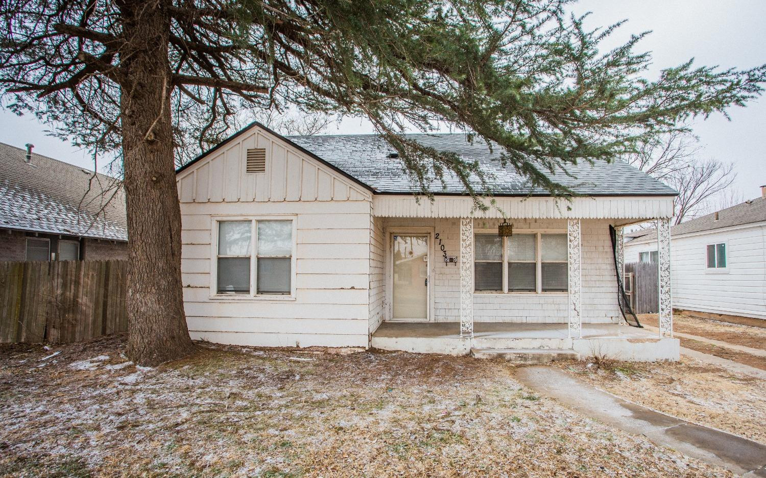2103 22nd Street Lubbock, TX 79411 - Photo 1 of 18 a front view of a house with a yard and garage