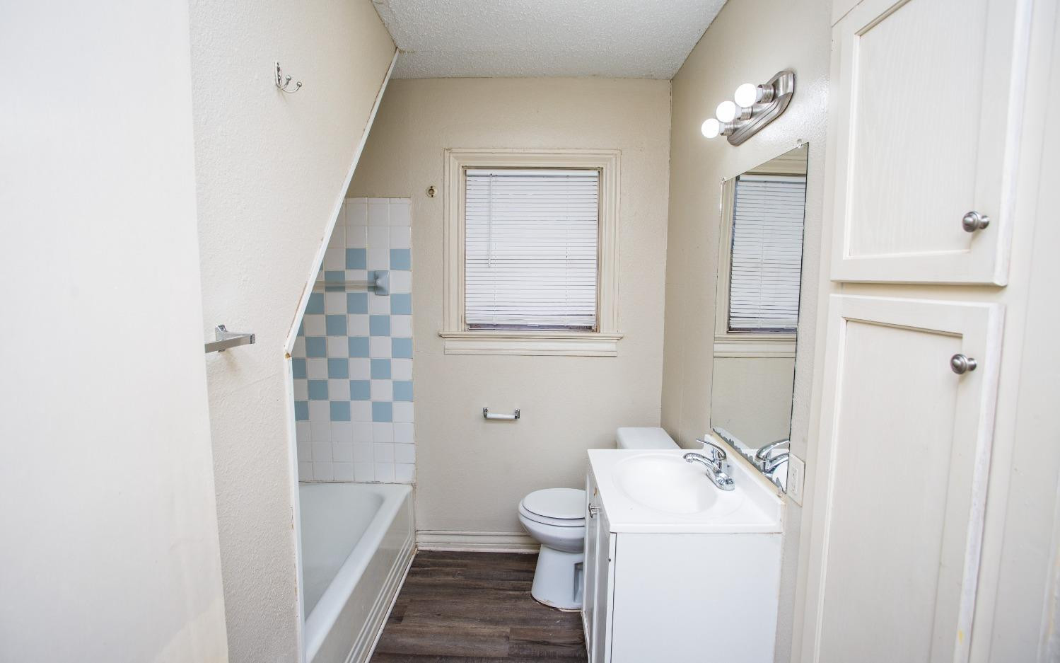 2103 22nd Street Lubbock, TX 79411 - Photo 11 of 18 a bathroom with a sink a toilet and shower