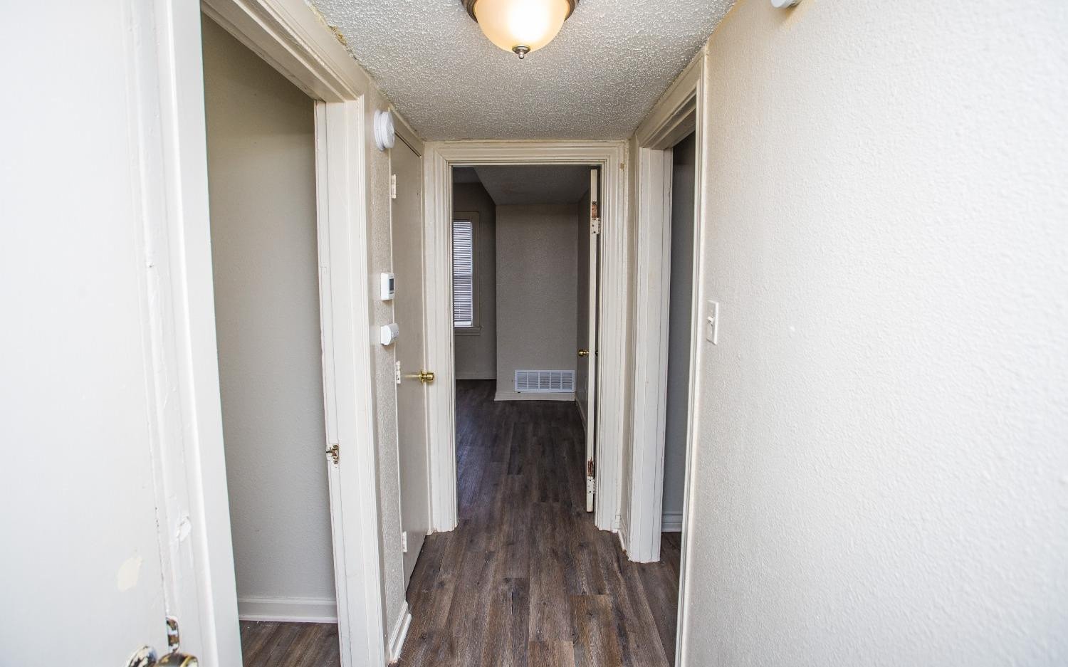 2103 22nd Street Lubbock, TX 79411 - Photo 15 of 18 a view of a hallway with wooden floor