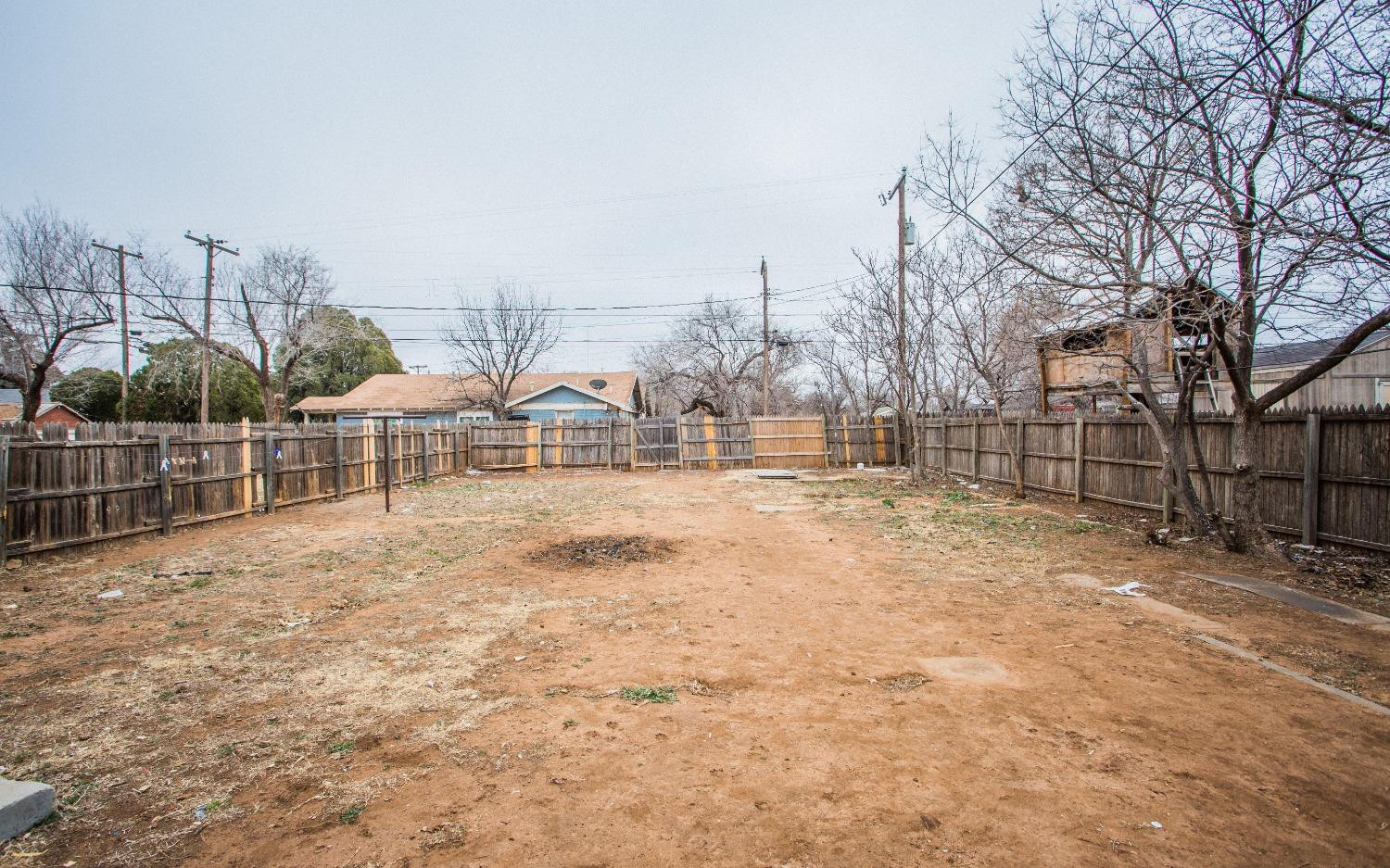2103 22nd Street Lubbock, TX 79411 - Photo 16 of 18 a view of a yard with wooden fence