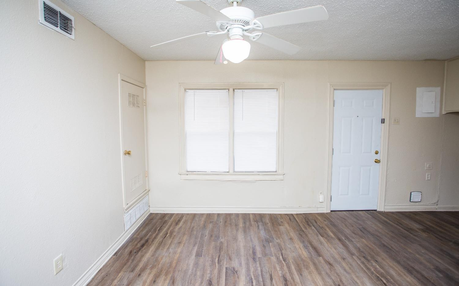 2103 22nd Street Lubbock, TX 79411 - Photo 5 of 18 wooden floor in an empty room with a window