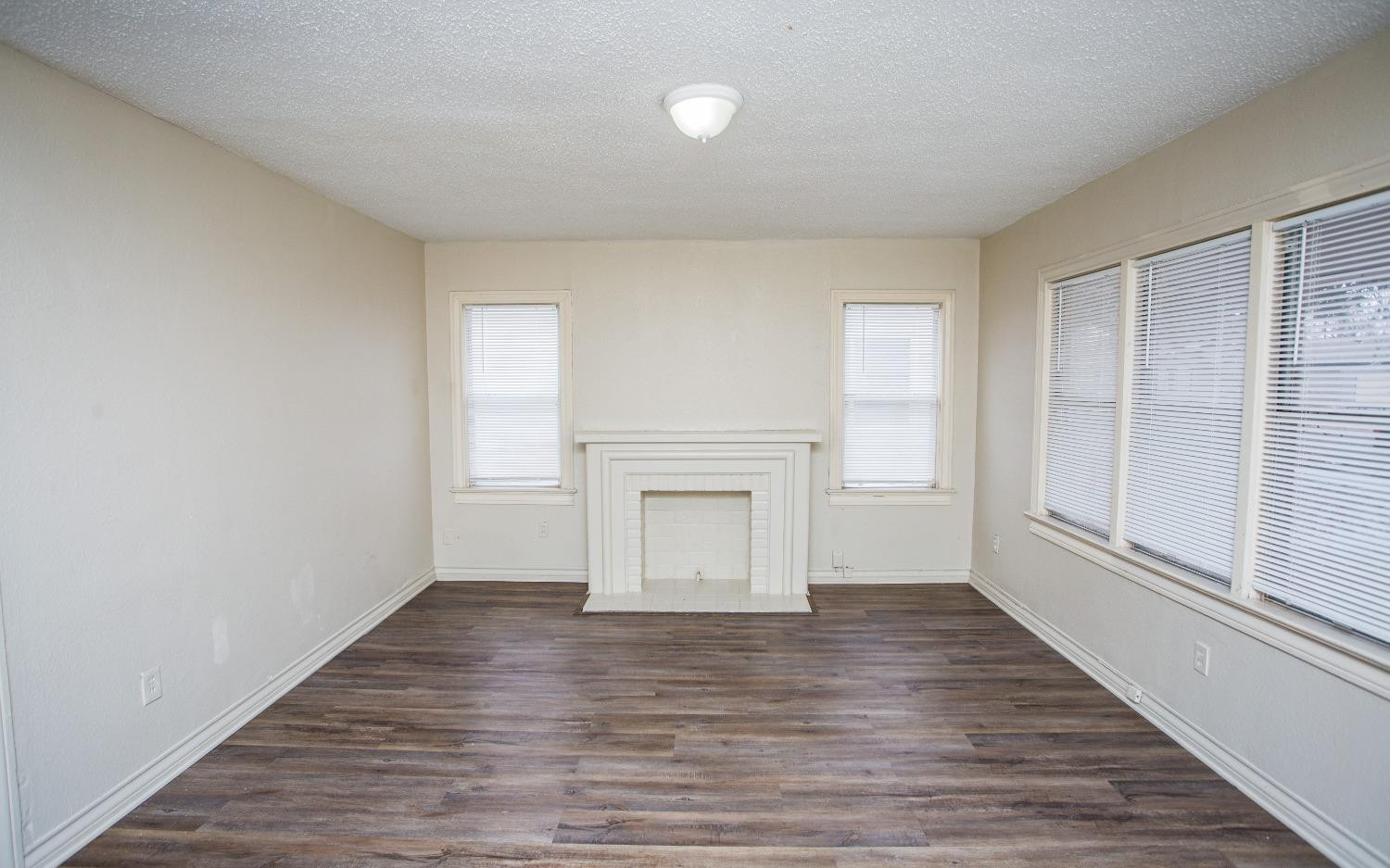 2103 22nd Street Lubbock, TX 79411 - Photo 6 of 18 wooden floor in an empty room with a window