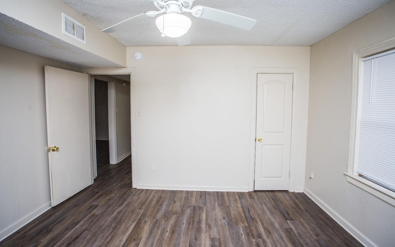 2103 22nd Street Lubbock, TX 79411 - Photo 9 of 18 an empty room with wooden floor and closet
