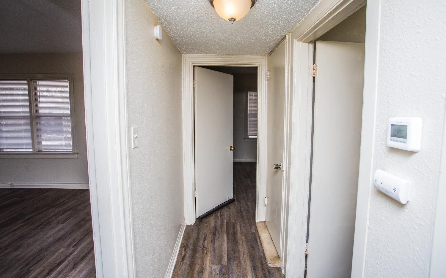 2103 22nd Street Lubbock, TX 79411 - Photo 10 of 18 a view of a hallway with wooden floor and a room