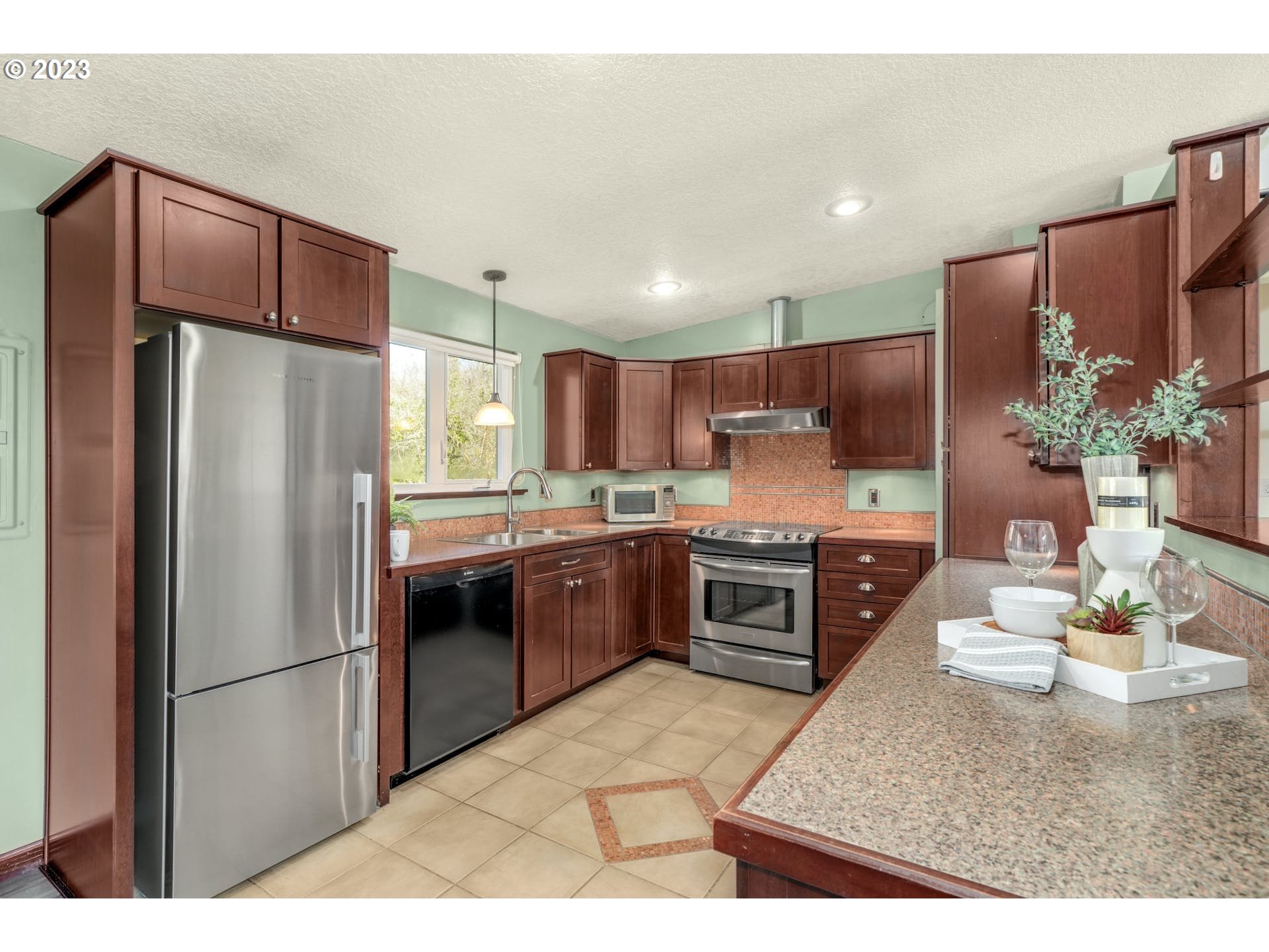5225 Southwest Oleson Road, Unit 10 Portland, OR 97225 - Photo 11 of 30 a kitchen with stainless steel appliances a refrigerator and a stove
