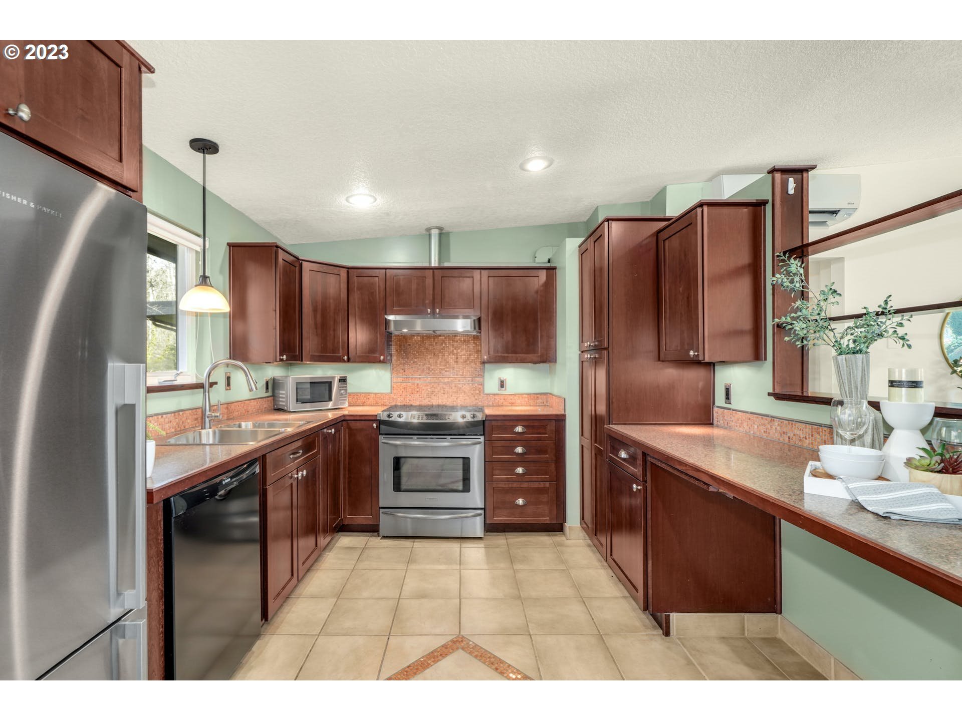5225 Southwest Oleson Road, Unit 10 Portland, OR 97225 - Photo 12 of 30 a kitchen with stainless steel appliances granite countertop a sink refrigerator and cabinets