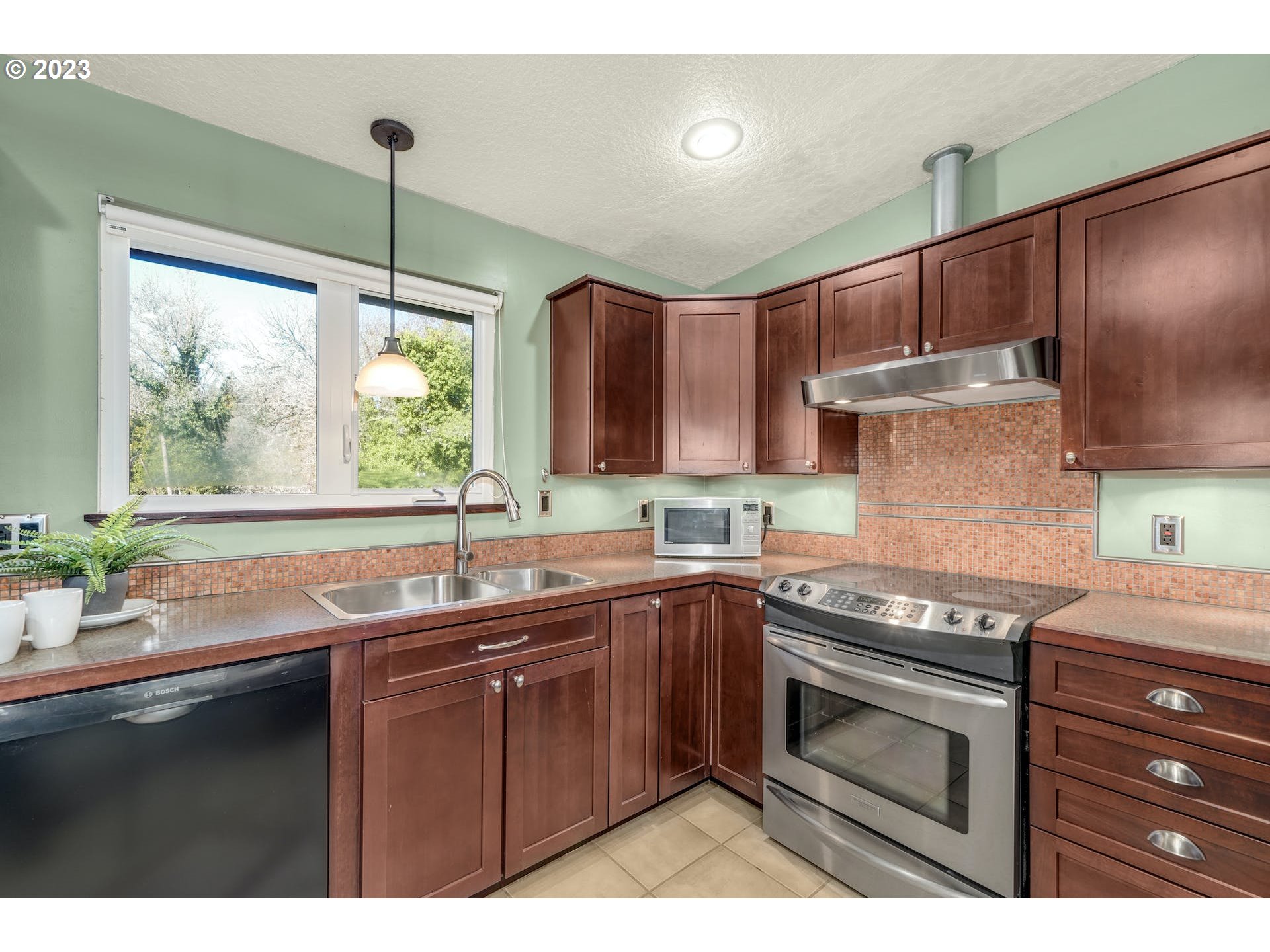 5225 Southwest Oleson Road, Unit 10 Portland, OR 97225 - Photo 13 of 30 a kitchen with a sink stove and cabinets